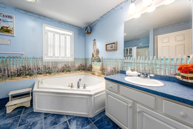 full bath with tile patterned floors, a bath, and vanity