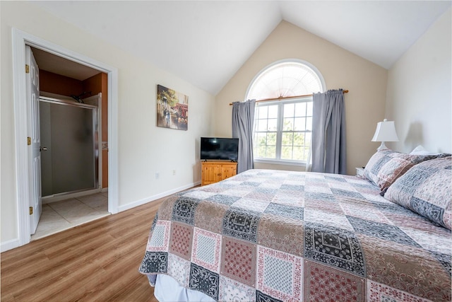 bedroom with baseboards, lofted ceiling, and wood finished floors