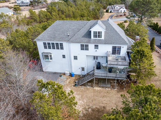 back of house featuring a shingled roof, stairs, central AC unit, and a wooden deck