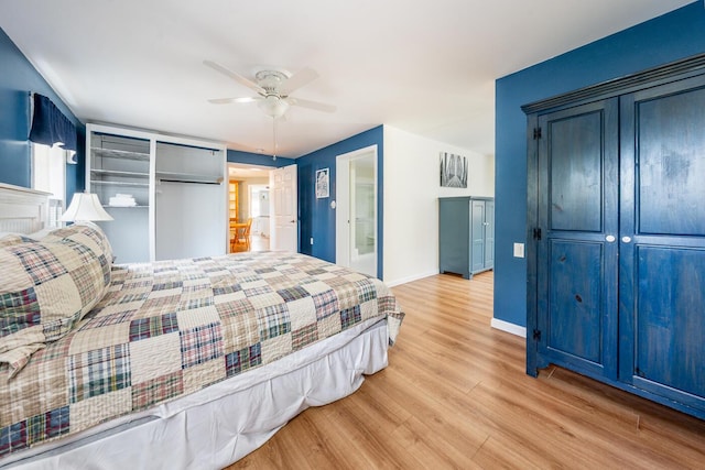 bedroom with a ceiling fan, baseboards, and wood finished floors