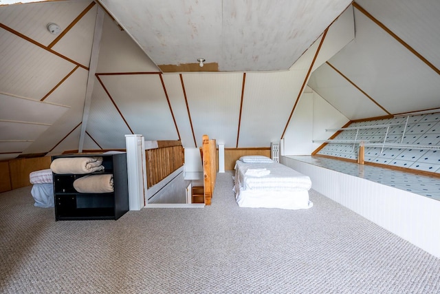 additional living space featuring wooden walls, carpet flooring, and lofted ceiling