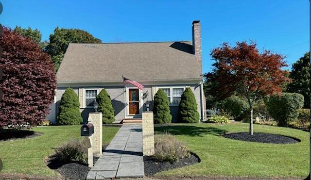 view of property exterior featuring a chimney, fence, and a gate