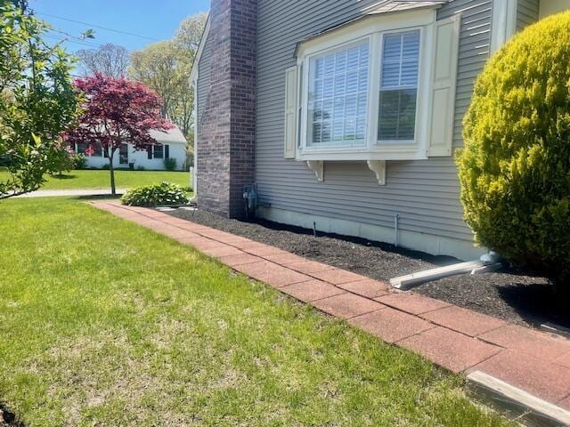 2 Spinning Brook Rd, South Yarmouth, MA 02664 - view of property exterior with a lawn and a chimney