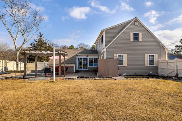 rear view of property featuring a fenced backyard, a lawn, a pergola, and a wooden deck