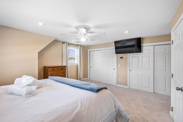 carpeted bedroom with recessed lighting, ceiling fan, baseboards, and two closets