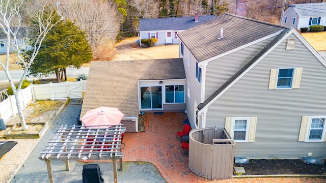 back of house featuring a fenced backyard, a gate, roof with shingles, and a patio