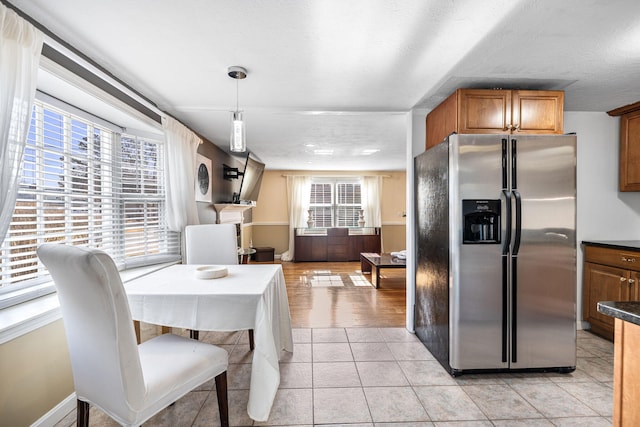 dining area with baseboards and light tile patterned floors