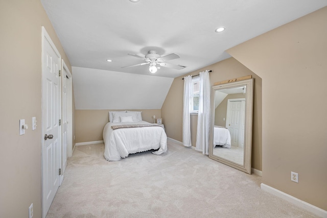 bedroom with a ceiling fan, carpet, vaulted ceiling, and baseboards