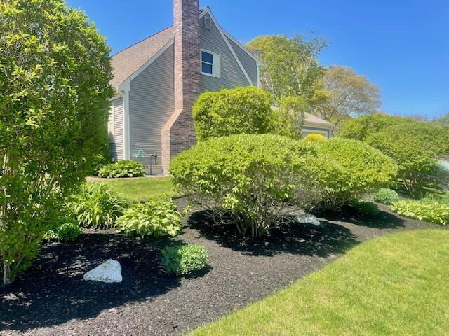 2 Spinning Brook Rd, South Yarmouth, MA 02664 - view of side of home with a chimney