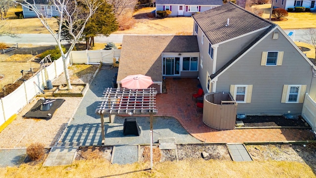 rear view of property featuring a fenced backyard and a patio area