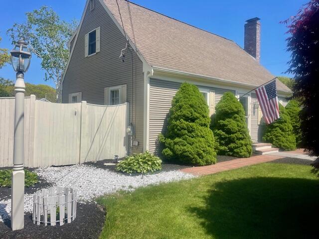 2 Spinning Brook Rd, South Yarmouth, MA 02664 - view of home's exterior featuring a chimney