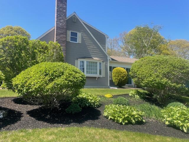2 Spinning Brook Rd, South Yarmouth, MA 02664 - view of property exterior with a chimney
