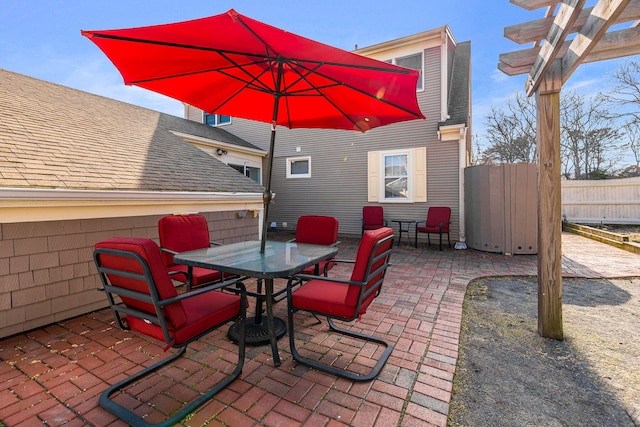 view of patio / terrace with fence, outdoor dining area, and a pergola