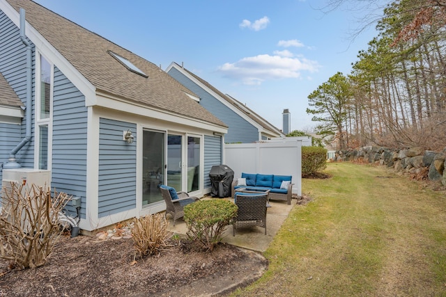view of yard with fence, an outdoor living space, and a patio