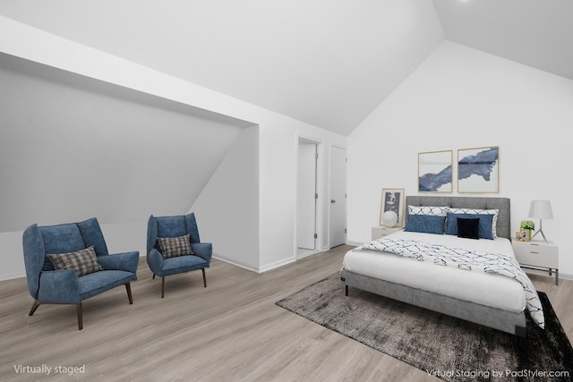 bedroom with high vaulted ceiling, baseboards, and wood finished floors
