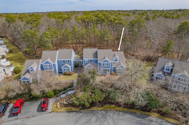 bird's eye view with a wooded view