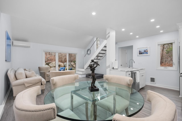 dining area with visible vents, an AC wall unit, recessed lighting, and a healthy amount of sunlight