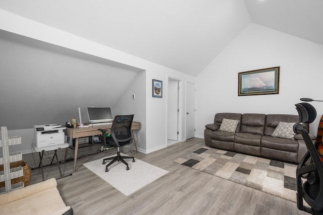 home office featuring baseboards, vaulted ceiling, and wood finished floors