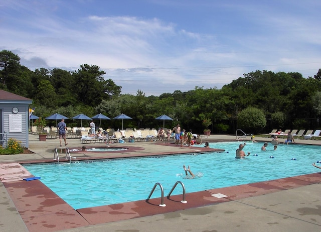 community pool featuring fence and a patio area