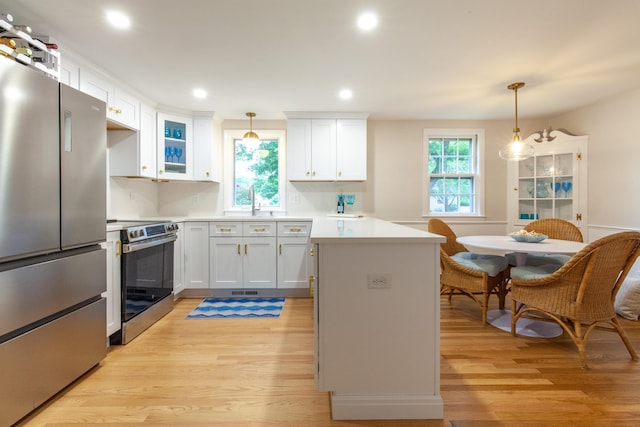 40 Highland Dr, Centerville, MA 02632 - kitchen featuring stainless steel appliances, a peninsula, light wood-type flooring, healthy amount of natural light, and recessed lighting