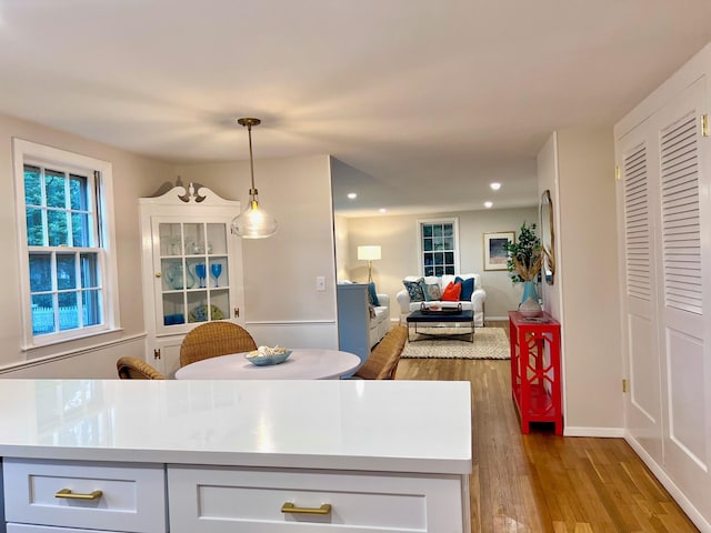 40 Highland Dr, Centerville, MA 02632 - kitchen with wood finished floors, open floor plan, light countertops, recessed lighting, and decorative light fixtures