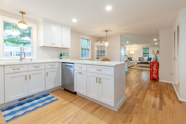 40 Highland Dr, Centerville, MA 02632 - kitchen with stainless steel dishwasher, a peninsula, light wood-type flooring, white cabinetry, and light countertops