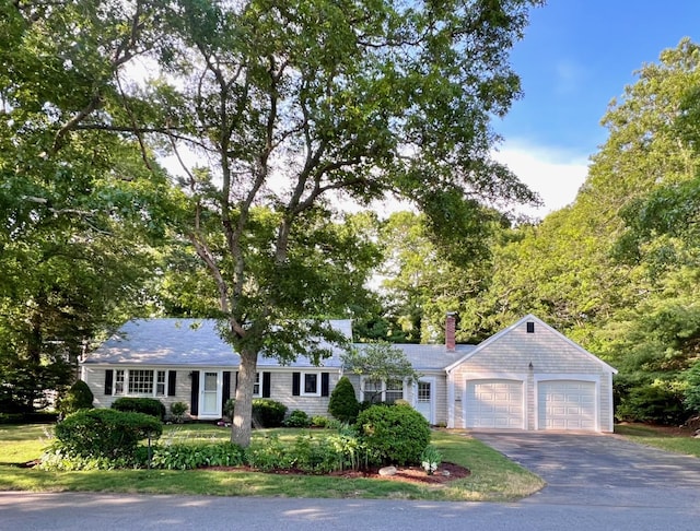 40 Highland Dr, Centerville, MA 02632 - single story home featuring a garage, asphalt driveway, and a chimney