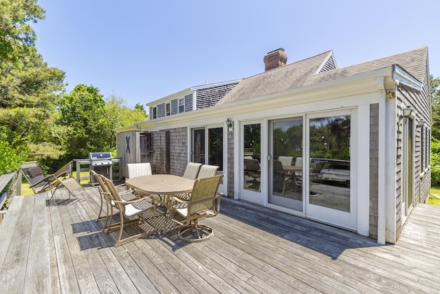 wooden terrace featuring a grill