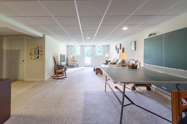 rec room featuring carpet and a drop ceiling