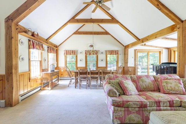 carpeted living room featuring wooden walls, a baseboard heating unit, high vaulted ceiling, beam ceiling, and ceiling fan with notable chandelier