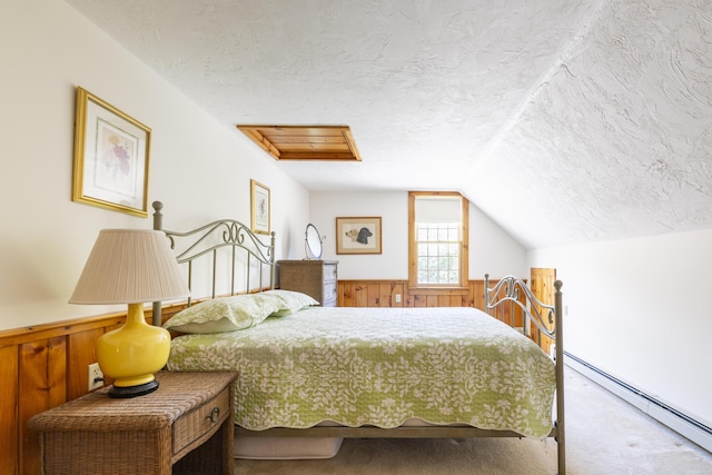 bedroom featuring a baseboard radiator, a textured ceiling, carpet floors, wood walls, and lofted ceiling