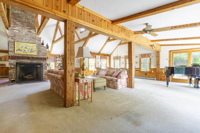 living room with a brick fireplace, a baseboard heating unit, plenty of natural light, and wooden walls