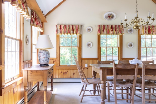 dining room with dark colored carpet, a chandelier, vaulted ceiling, and a baseboard heating unit