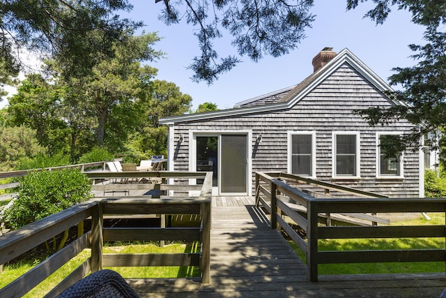 rear view of house with a wooden deck