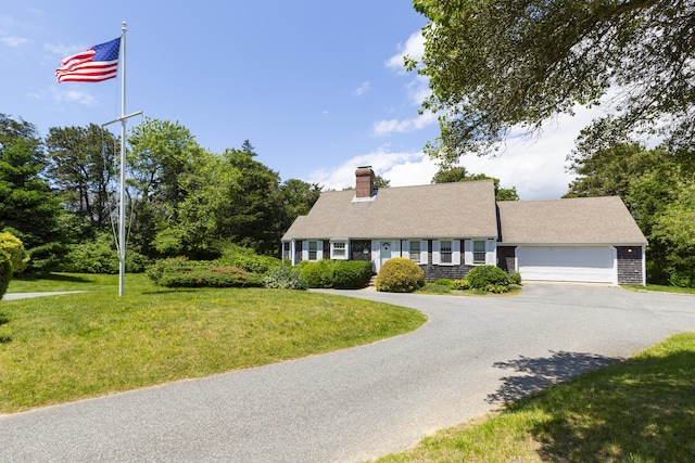 view of front facade with a garage and a front lawn