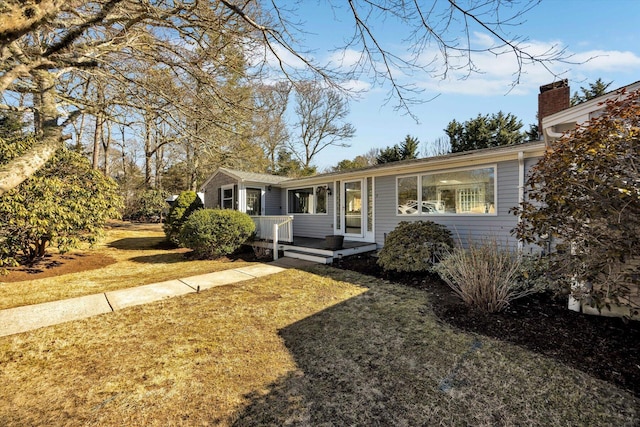 ranch-style home with a front lawn