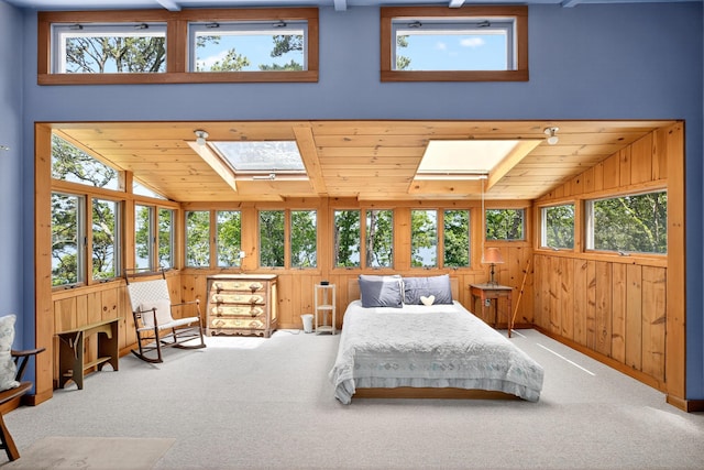 17 Gull Haven Ln, Wellfleet, MA 02667 - bedroom with a skylight, wood walls, carpet floors, multiple windows, and vaulted ceiling