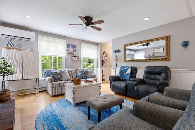 33 Rogers Rd, Brewster, MA 02631 - living room featuring an AC wall unit, ceiling fan, light wood-style flooring, wainscoting, and a baseboard heating unit