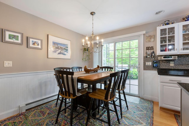 33 Rogers Rd, Brewster, MA 02631 - dining room featuring a chandelier, light wood finished floors, wainscoting, and baseboard heating