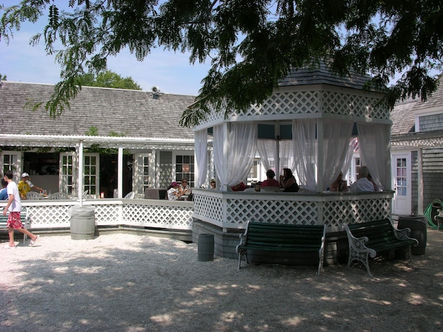 back of property featuring a gazebo