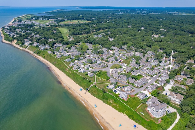 birds eye view of property with a water view and a beach view