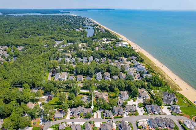 birds eye view of property featuring a beach view and a water view