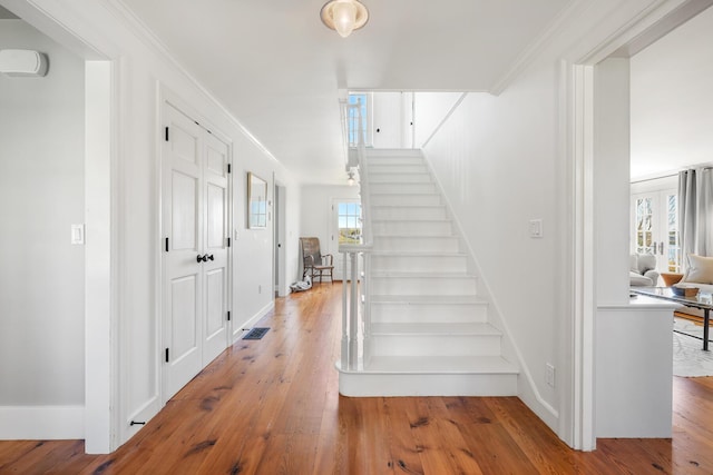23 Oyster Pond Ln, Chatham, MA 02633 - stairway featuring hardwood / wood-style floors and crown molding