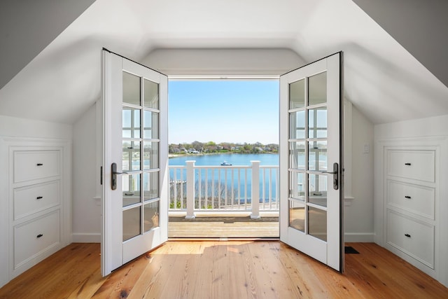 23 Oyster Pond Ln, Chatham, MA 02633 - bonus room featuring french doors, vaulted ceiling, wood finished floors, and a water view