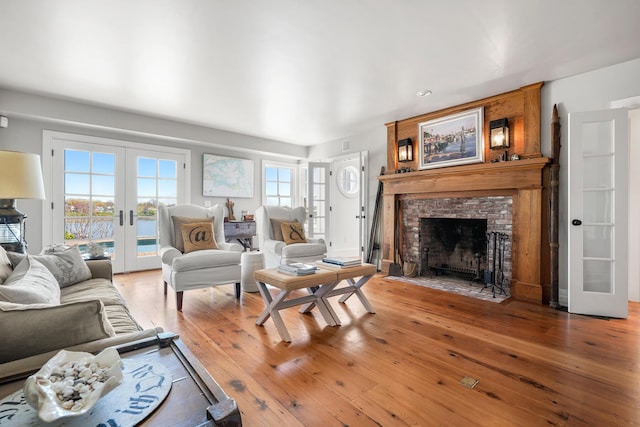 23 Oyster Pond Ln, Chatham, MA 02633 - living area with french doors, wood-type flooring, and a fireplace