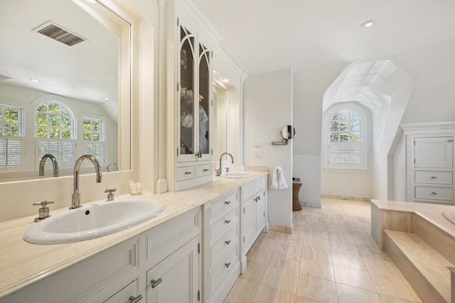 23 Oyster Pond Ln, Chatham, MA 02633 - full bathroom with a tub to relax in, double vanity, lofted ceiling, and recessed lighting