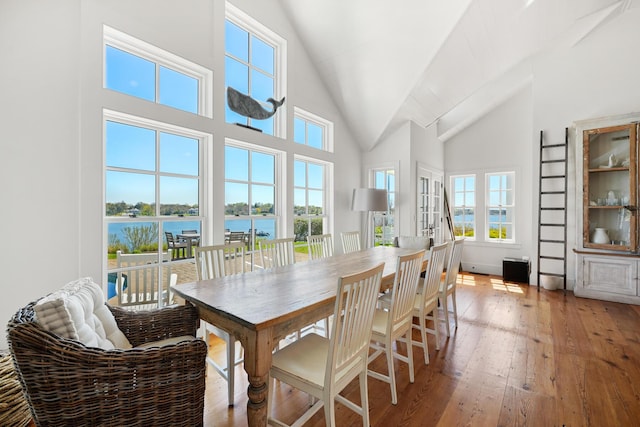 23 Oyster Pond Ln, Chatham, MA 02633 - dining space featuring light wood-style flooring, high vaulted ceiling, and a water view