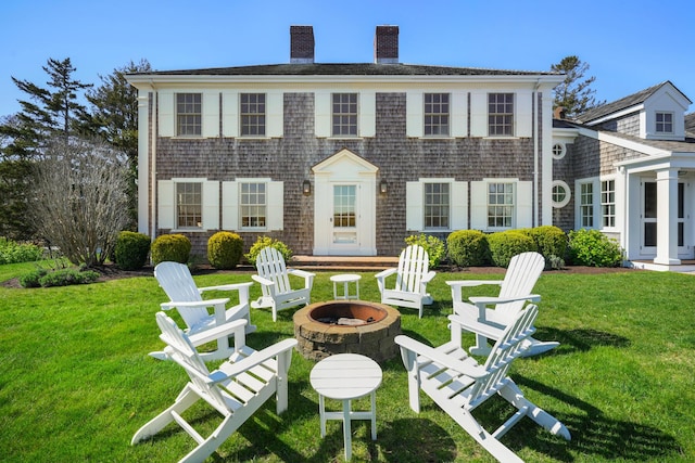 23 Oyster Pond Ln, Chatham, MA 02633 - rear view of property featuring a fire pit, a yard, and a chimney