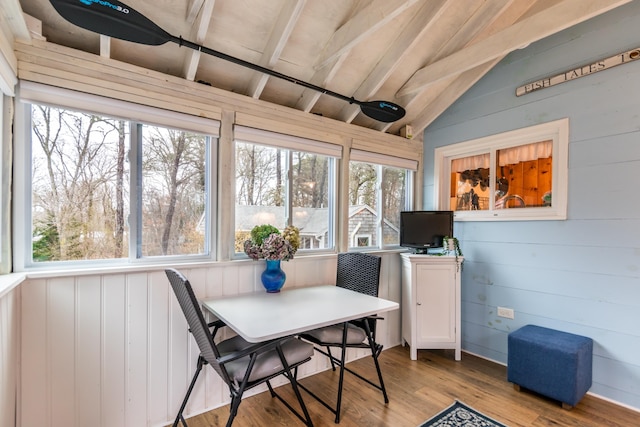 sunroom featuring plenty of natural light and beamed ceiling