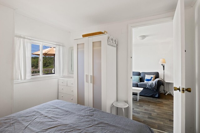 168 Shore Rd Unit 5, Truro, MA 02666 - bedroom with ornamental molding and wood finished floors